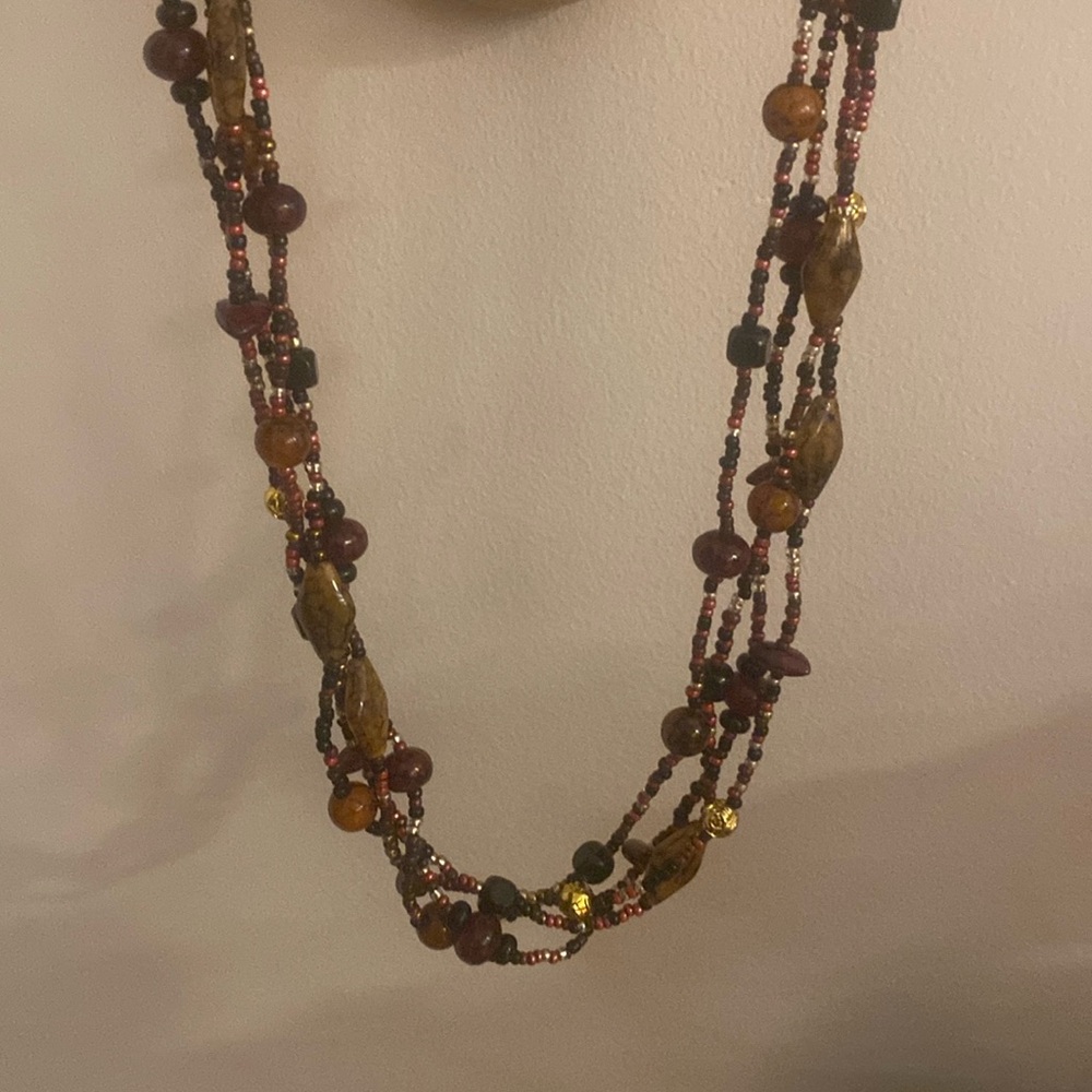 4 strand beaded necklace. Various larger beads stones & seed beads.About 28 in